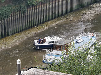 A small boat in a body of water  Description automatically generated