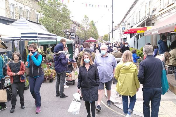 A crowd of people in Devonshire Road Chiswick