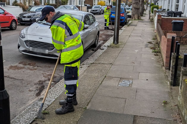 workman weeding