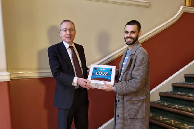 Andy Slaughter MP receiving his cake from Islamic Relief Charity