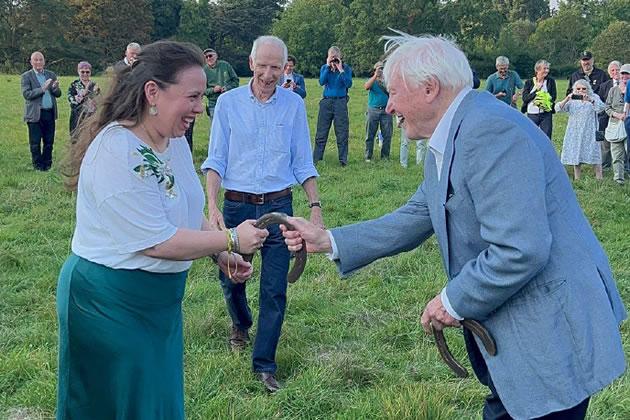 Councillor Gabriella Giles receiving her shire-horseshoe from Sir David Attenborough at a ceremony at Syon House, September 2024.