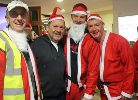 grup shot with three of the volunteers with their beards off 