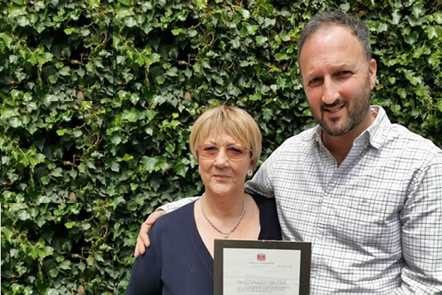 Penny Harrison with son Paul and the letter they received from the Queen