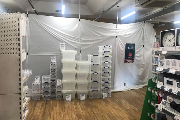 Plastic sheeting current covers the area where the new post office counters will be