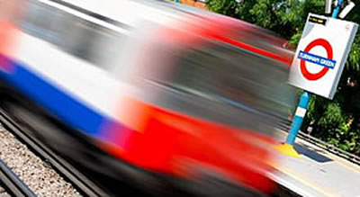 Piccadilly line train speeds through Turnham Green