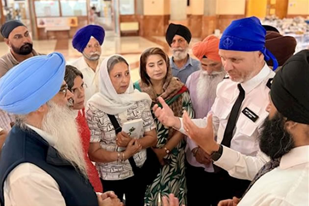 Matt Jukes (right) talks to members of the Sri Guru Sabha Gurdwara