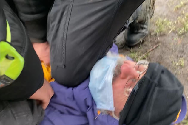 Dimitri being restrained by security guards. Picture: Extinction Rebellion Wandsworth 