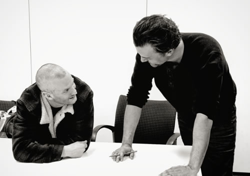 the two men on stage in a rehearsal image 