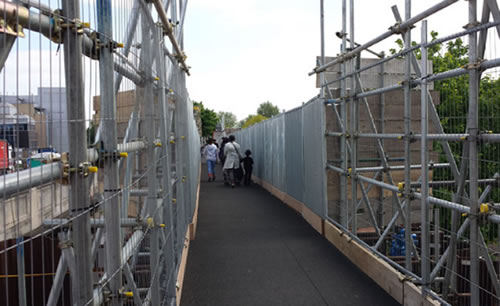 power road bridge on north circular road with people crossing temporary structure 